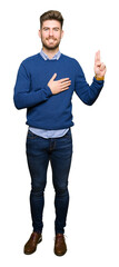 Young handsome bussines man Swearing with hand on chest and fingers, making a loyalty promise oath