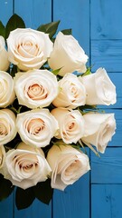 Top view of Mother's day holiday composition with beautiful white roses in corners on blue wooden background