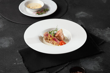 Grilled Tuna Fillet with Tonnato Sauce on Black Slate Background