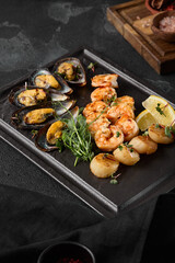 Assorted Seafood Elegance Shrimp, Scallops, and Mussels on a Dark Plate