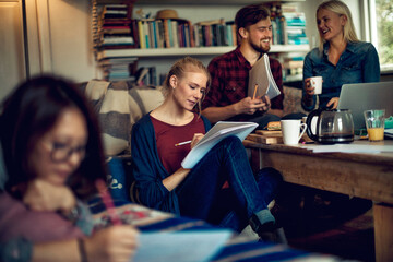 Diverse student friends studying together at home