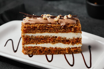 Delicate Slice of Carrot Cake with Creamy Frosting and Artistic Chocolate Drizzle