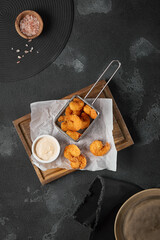 Golden Fried Shrimp in Basket with Dipping Sauce on Dark Rustic Background - Ample Negative Space...