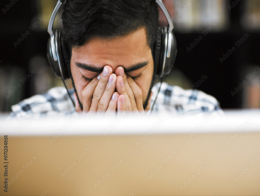Poster man, university student and burnout on computer with headphones in library for internet, online erro
