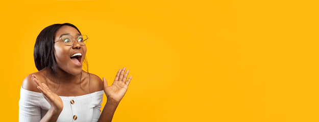 Wow. Excited Afro Girl Shouting Holding Hands Near Face Standing Over Orange Studio Background. Panorama, Free Space