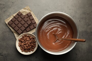 Chocolate dough in bowl and ingredients on grey table, flat lay