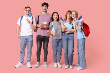 Fototapeta premium Group of students with French flags on pink background