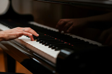 Fototapeta premium Close-up of woman playing the piano.