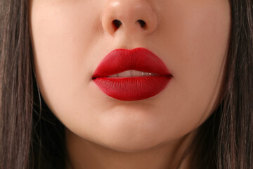 Fototapeta premium Young woman with red lips, closeup