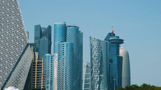 View of Doha city business center with futuristic skyscrapers and high-rise buildings, Qatar. Modern architecture in Gulf countries, Middle East