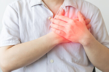 Man clutching his chest from acute pain from heart attack symptom. Severe heartache, man suffering...