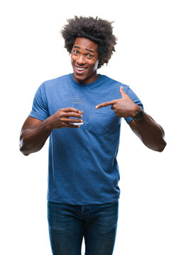Afro american man drinking glass of water over isolated background very happy pointing with hand and finger