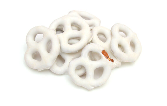 White chocolate covered pretzels on white background