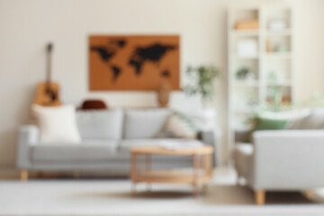 Blurred view of living room with sofa, table and world map on white wall