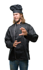 Young handsome cook man with long hair over isolated background disgusted expression, displeased...