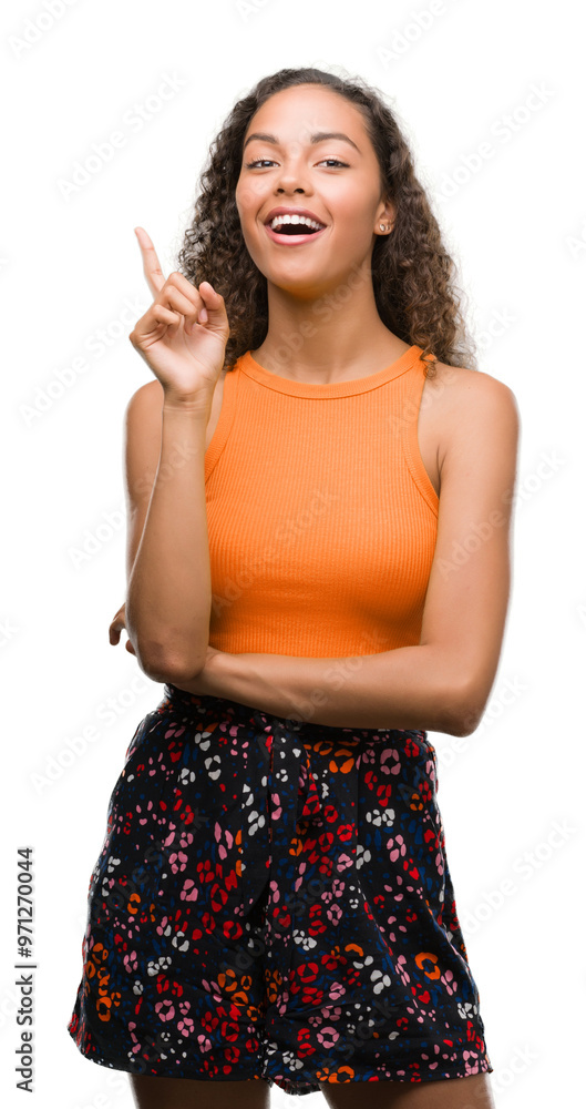 Canvas Prints Young hispanic woman surprised with an idea or question pointing finger with happy face, number one