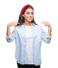 Young beautiful arab woman wearing sunglasses over isolated background looking confident with smile...