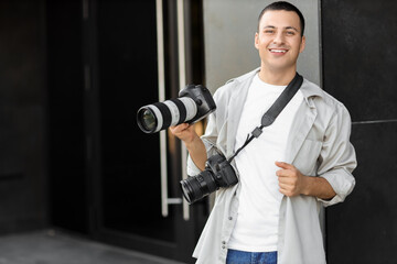 Male photographer with modern camera outdoors