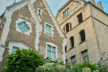 A vibrant scene unfolds in Riga's Old Town, where a colorful array of buildings stands side by...