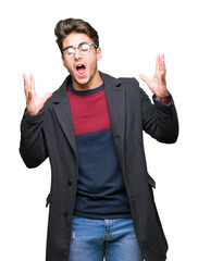 Young handsome elegant man wearing glasses over isolated background celebrating mad and crazy for...
