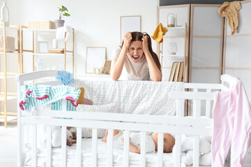 Young mother suffering from postnatal depression at home