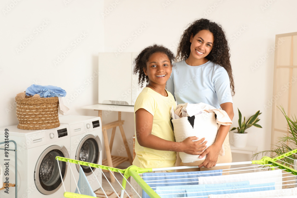 Sticker African-American woman and her daughter with laundry at home