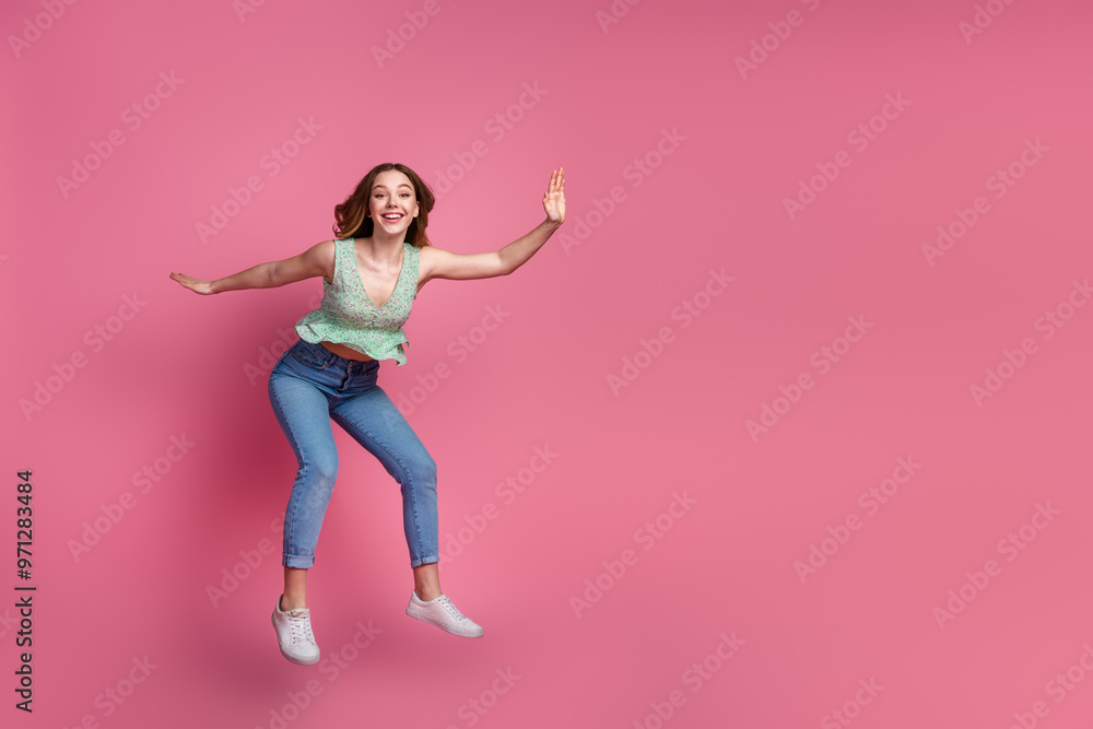 Wall mural Full body portrait of pretty young girl jump fall empty space wear top isolated on pink color background