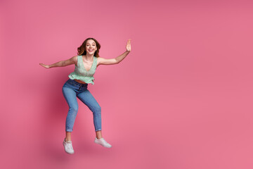 Full body portrait of pretty young girl jump fall empty space wear top isolated on pink color...