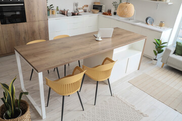 Wooden table and chairs in interior of modern dining room