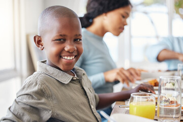 Fototapeta premium Child, portrait and food with black family in home for Thanksgiving celebration, festive holiday and brunch. Support, love and party with people and lunch for nutrition, grateful and tradition