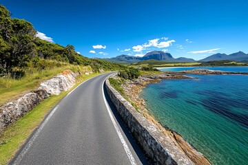A scenic drive along Tasmaniaâ€™s Great Eastern Drive, with stunning coastal views and lush green countryside on either side