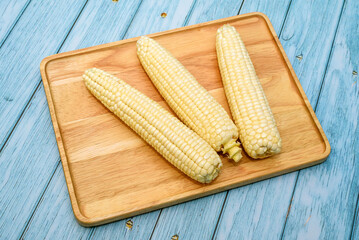 Fresh Corn Cobs on Wooden Board