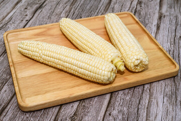 Fresh Corn Cobs on Wooden Board