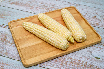 Fresh Corn Cobs on Wooden Board