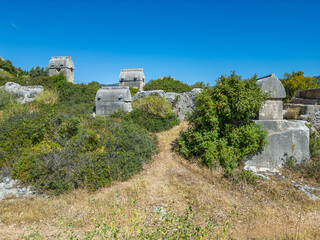 Fototapeta premium The ancient city of Simana, founded by the Lycian civilization, the sunken city of Kekova, rock tombs, castle, sea and nature reveal its magnificence.
