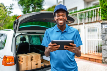 African young courier using digital tablet to deliver packages