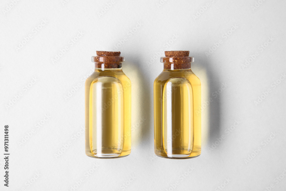 Canvas Prints Essential oils in bottles on light background, top view