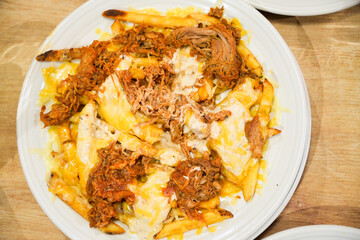 A plate of food with a lot of cheese and meat on it