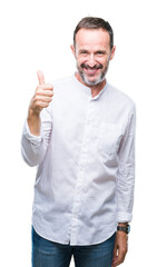 Middle age hoary senior man over isolated background doing happy thumbs up gesture with hand. Approving expression looking at the camera with showing success.