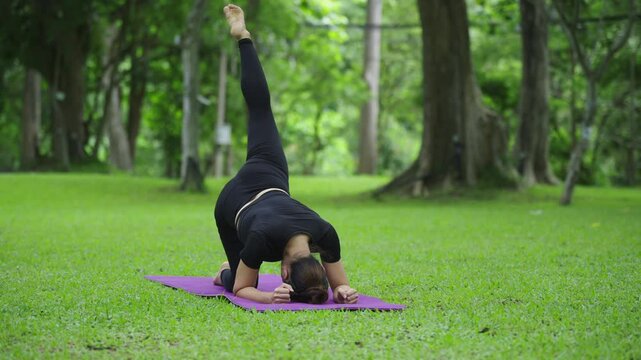 Athletic woman performing one legged dog yoga pose