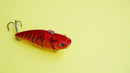   Ratlin: plastic fishing lure on a pistachio background, with space for text. bait for catching...