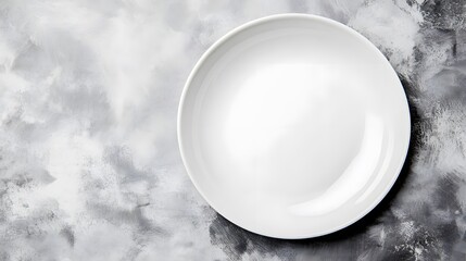Empty white plate on a textured gray background.