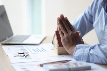 Male businessman, real estate sales representative, protecting the house