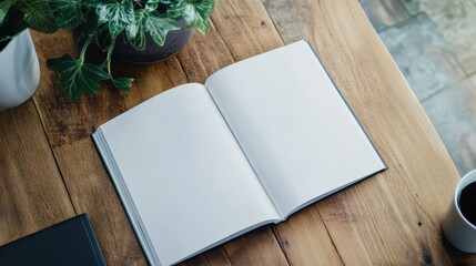 A book is open on a wooden table with a potted plant next to it. The book is white and the table is made of wood