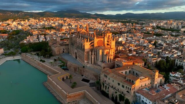 orbiting aerial view of cathedral of Palma de Mallorca, Palma de Mallorca cityscape. Cathedral of Santa Maria, Royal Palace of La Almudaina. Balearic Islands. Spain