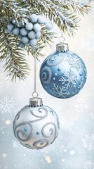 Beautiful blue and white holiday ornaments hanging from a frosted pine branch in a winter setting