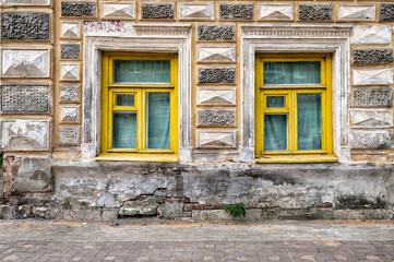 The facade of ancient building with windows.