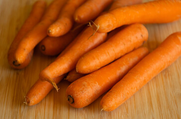 Bunch of Fresh Organic Carrots on a Wooden Chopping Board Close-Up