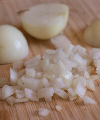 Chopped Onion on Wooden Board Close-Up on Dark Background
