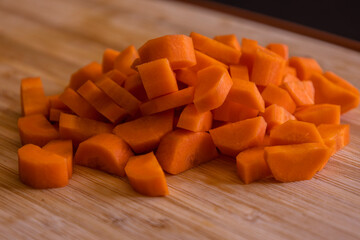 Fresh Organic Chopped Carrots on a Wooden Chopping Board Close-Up